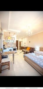 a large living room with a bed and a couch at Beautiful Tbilisi on Meskhishvili Turn in Tbilisi City