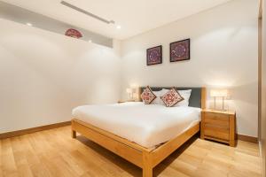 a bedroom with a large white bed and two lamps at Ocean Apartment Two Bedrooms in Danang +40 photos