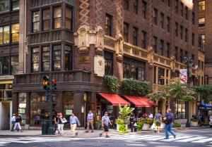 a group of people crossing a street in front of a building at Library Hotel by Library Hotel Collection in New York