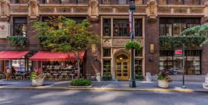 een bakstenen gebouw met tafels en stoelen ervoor bij Library Hotel by Library Hotel Collection in New York