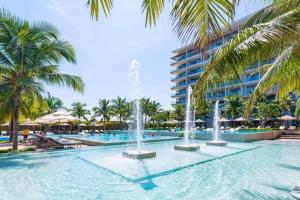 a large swimming pool with fountain in front of a building at Ocean Apartment Two Bedrooms in Danang
