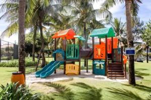 a playground in a park with palm trees at Ocean Apartment Two Bedrooms in Danang