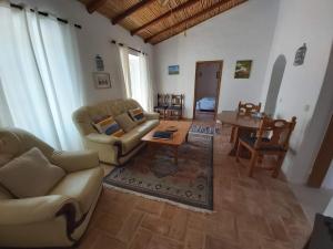 a living room with couches and a table at Casa Delfim - Casa Azul in Alte