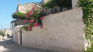 a retaining wall with flowers on it at Studio Apartments Kuljiš in Vis