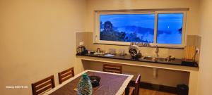 a dining room with a table and a window at Sky High Villa Annex in Kodaikānāl
