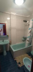a bathroom with a sink and a tub and a toilet at As Mariñas 92 in Boiro +16 photos