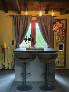 a bar with two stools in front of a window at Trnova Ruzica in Trnovac +4 photos
