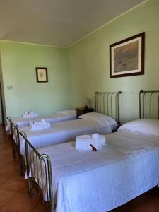 a group of four beds in a room at Motel Cosmera in Savigliano