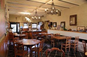 ein Restaurant mit Holztischen und -stühlen in einem Raum in der Unterkunft Het Pachthof in Borlo