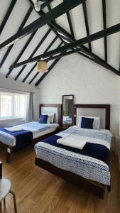 a bedroom with two beds in a room at Gatwick Castle B&B in Horley +37 photos
