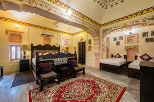 a room with two beds and a red rug at Hotel Shahi Palace Mandawa in Mandāwa