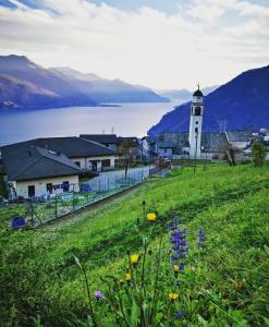 a lighthouse on a hill with a field of flowers at Casa Maya in Stazzona