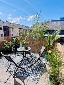 a patio with a table and chairs and a fence at Ropewalks City Centre Apartment with Roof Terrace in Liverpool