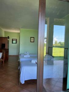 a bedroom with two beds and a sliding glass door at Motel Cosmera in Savigliano