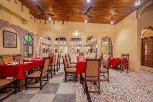 a dining room with red tables and chairs at Hotel Shahi Palace Mandawa in Mandāwa