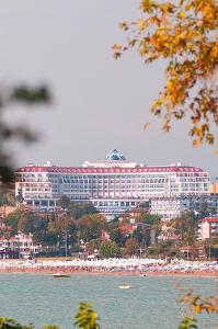a large building on the shore of a beach at Side Prenses Resort Hotel & Spa in Side