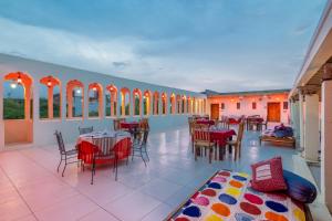 a large room with tables and chairs and windows at Hotel Shahi Palace Mandawa in Mandāwa
