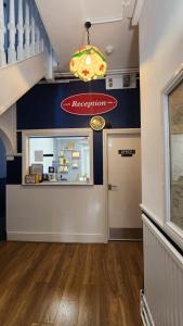 a shop with a restaurant sign on the wall at Gatwick Castle B&B in Horley