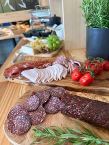 a table with meats and vegetables on a cutting board at Bella Monte in Szczyrk