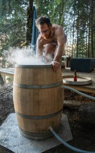 a man is standing inside of a barrel at Mirror globe Kandasphere in Saint-Gervais-les-Bains