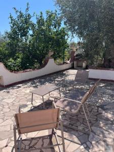 two chairs and a table on a patio at Villa Gargano in Mattinata +55 photos