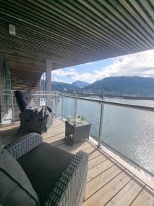 a balcony with a couch and a view of the water at The Seaview Suite - Tromsø harbour! in Tromsø
