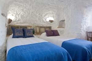 a bedroom with two beds with blue and white sheets at Balcones de Piedad in Los Balcones +273 photos