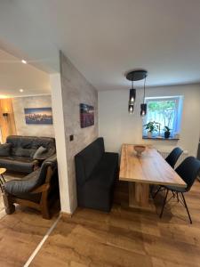 a living room with a table and a couch at Ferienwohnung E in Soltau