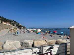 a beach with a bunch of people on it at Gli Oleandri in Ospedaletti +10 photos