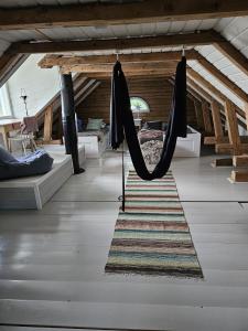 a living room with a hammock in a room at Kieloranta in Kuopio