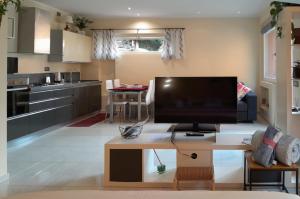a living room with a large flat screen tv at La Casina in Laglio +9 photos