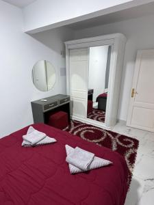 a bedroom with a red bed with a mirror at Casa Lydia in Naama Bay in Sharm El Sheikh