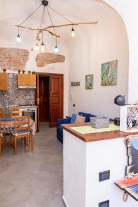 a kitchen and living room with a blue couch at La Casa di Dario in La Maddalena