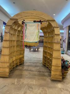 a wooden archway with a blanket hanging over it at cara and toby in Sao Paulo