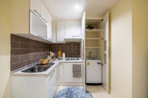 Makkasanにあるlucky homeのシンクと冷蔵庫のある小さなキッチン