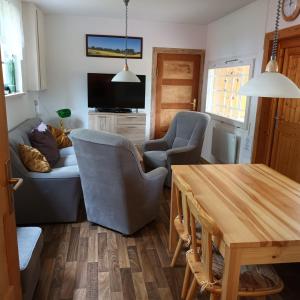 a living room with a couch and chairs and a table at Haus Eckstein in Lohme