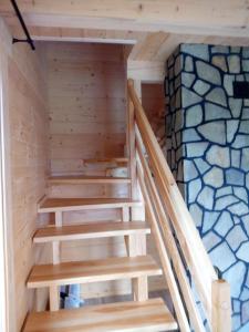 a staircase in a sauna with a stone wall at Słoneczna Chata dom Kasina Wielka in Kasina Wielka