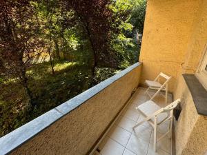 a balcony with two chairs and a window at Castle Hill Hideaway in Budapest