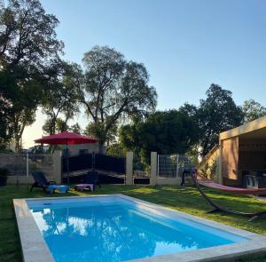 a swimming pool in a yard with a playground at Agréable rez de jardin avec Piscine et Jacuzzi in Cervione