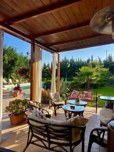 a patio with chairs and tables on a patio at Tenuta Seredipà in Castellammare del Golfo