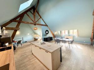 a large room with a kitchen and a dining room at Le CoqLoft in Coquelles