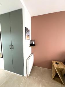 a room with a refrigerator and a table in it at Studio rénové proche de la plage in Tarnos