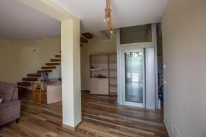 a living room with a staircase and a room with a door at La terrazza sulle Madonie in Calcarelli