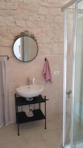 a bathroom with a sink and a mirror at Casa alloggio Jolanda in Ceglie Messapica
