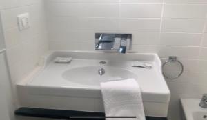 Baño blanco con lavabo y toalla en B&B Campagna Casagrande, en Recco 10 fotos más