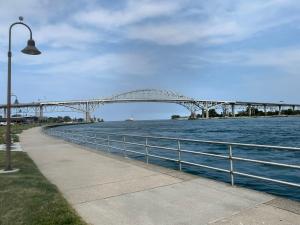 a bridge over a body of water with a street light at The Water Street House in Port Huron