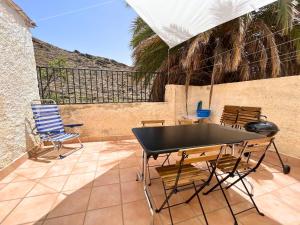 a ping pong table and chairs on a patio at La Casita Gergaleña, Confort in Gérgal