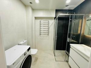 a bathroom with a shower and a toilet and a sink at Apartament new 10 in Căuşeni