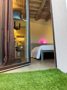 a view of a bedroom with a bed and a mirror at URBAN PRIVATE SPA in Porto SantʼElpidio
