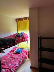 a bedroom with two bunk beds and a window at Apartamento Playa de Barro in Barro de Llanes